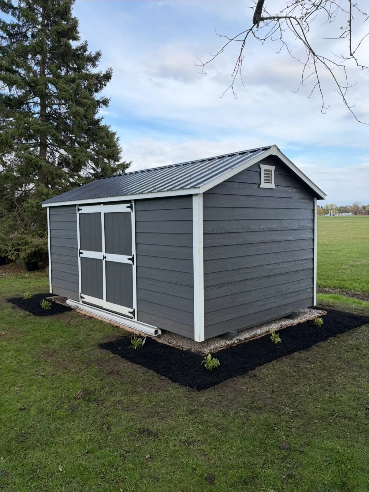 We’re back at it, turning a blank space around the shed into a brand-new focal point.
